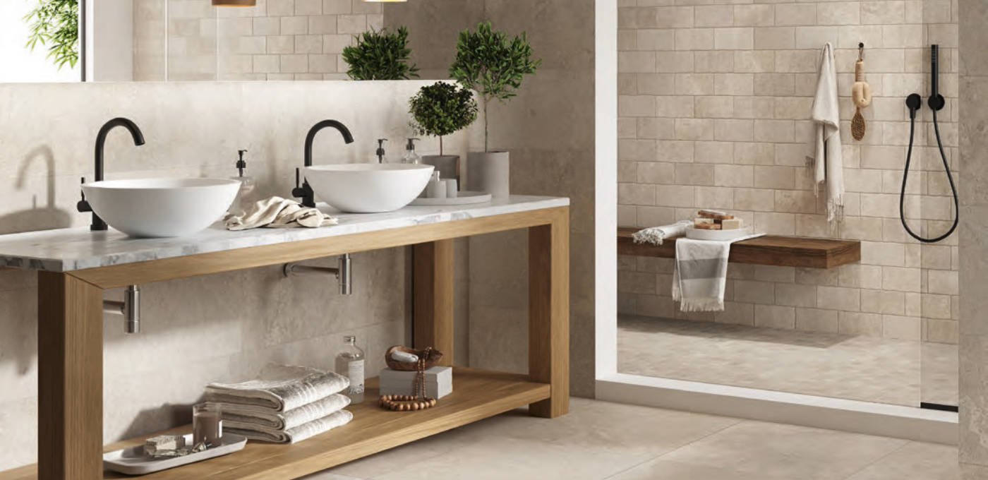 Matte ecru rectangular porcelain floor and wall tile featured in bathroom scene with stand up shower and double sink