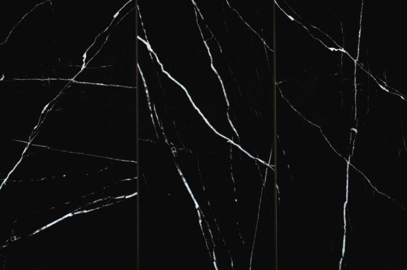 Glossy polished black marble look porcelain floor and wall tile with white veining, size 12" x 24", arranged vertically