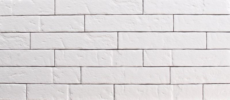 Matte white rectangular plank ceramic subway wall tile, size 2" x 10", stacked like bricks