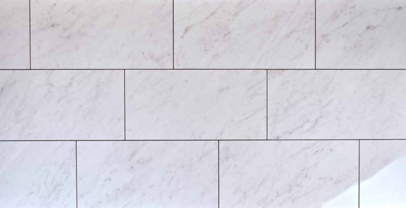 Polished white marble look alike wall and floor tile, size 12" x 24"