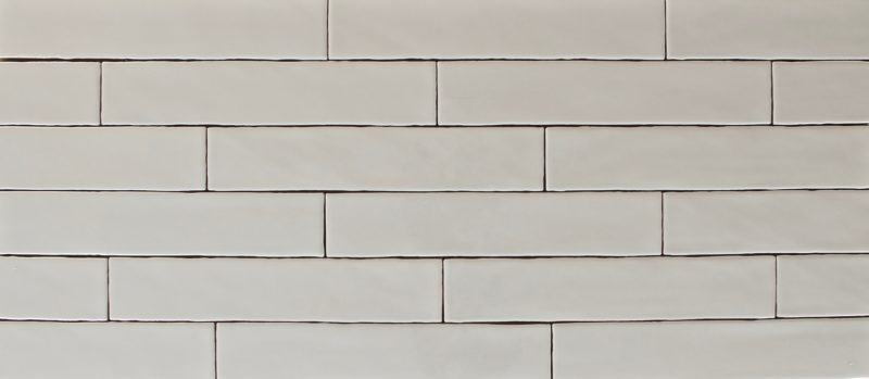 Glossy beige nude rectangle ceramic subway wall tile, size 2" x 10", stacked like bricks
